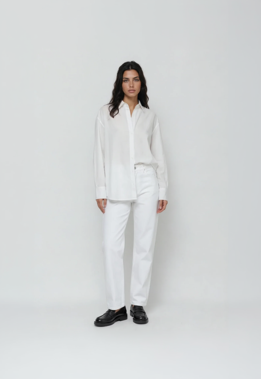 Person wearing a white outfit with black shoes on a plain background